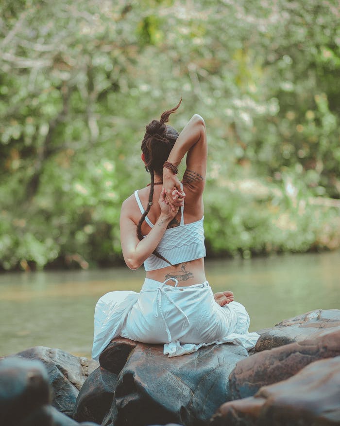 Mastering the First Impression: Your intriguing post title goes here A woman in a yoga pose by a calm river, surrounded by nature, embodying peace and tranquility.