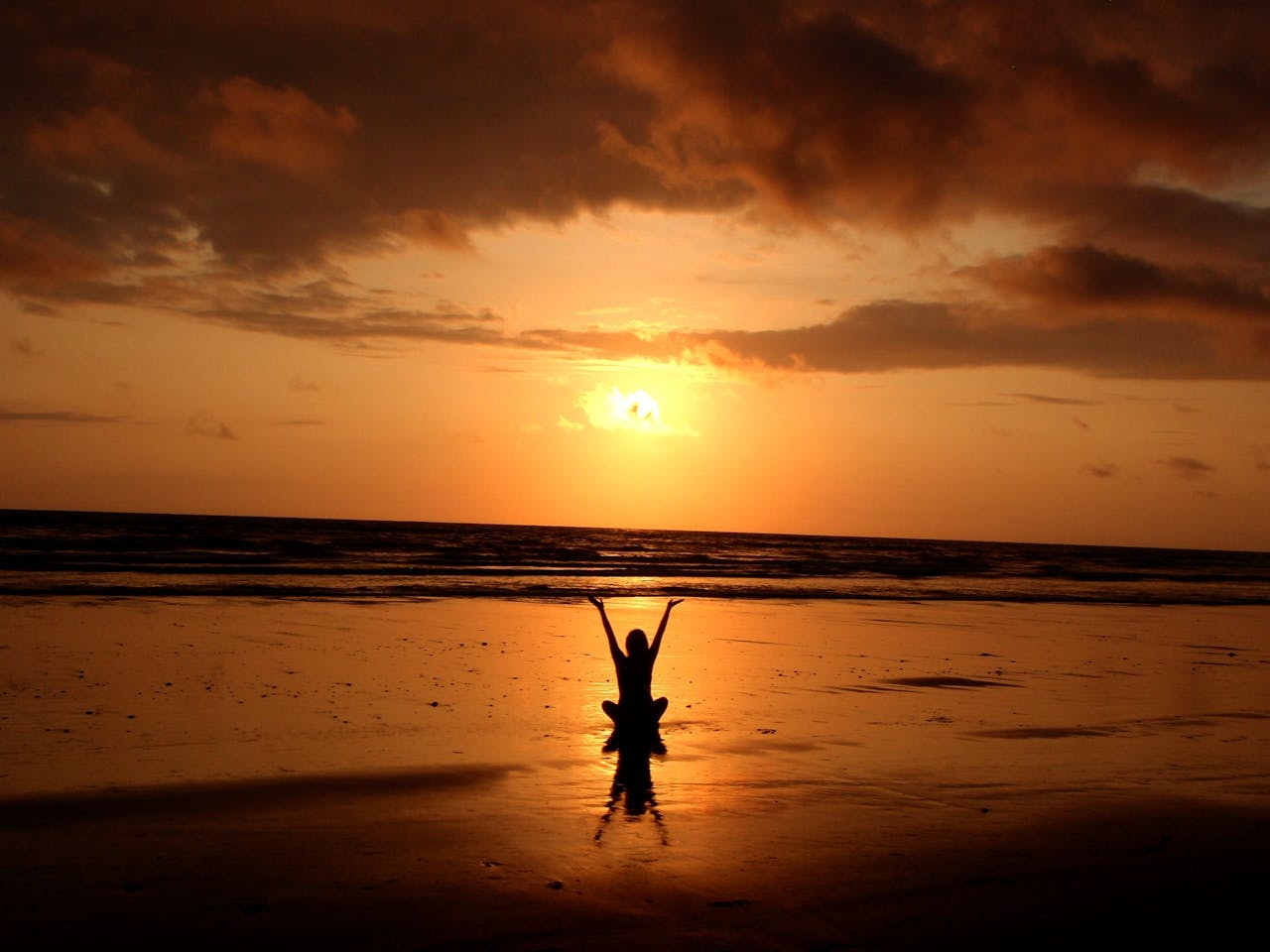 services-img Peaceful meditation silhouette at sunset on a serene beach.